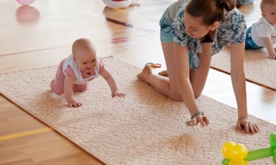 Crawling baby at 6 months with mom