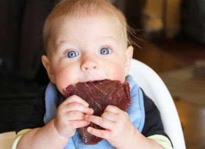 Baby eating meat