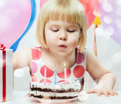Blowing out the candles by a child
