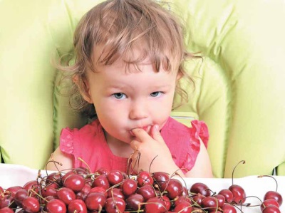 Baby with sweet cherry